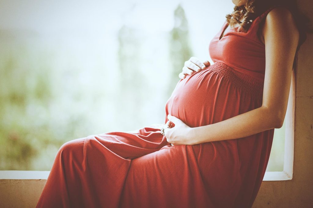 Pregnant woman receiving chiropractic care